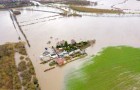 Flooded fields and farm house from the River Aire during a large flood after a storm.