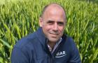 Professor Mario Caccamo in front of a wheat field