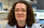 Dr Julia Lambret Frotte, sat in a laboratory