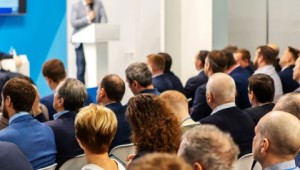 Man speaking at lantern in front of a crowd