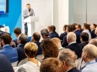 Man speaking at lantern in front of a crowd