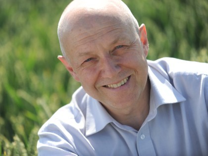 Professor Andy Greenland in a field on wheat at NIAB