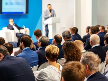 People listening to a speaker at a conference