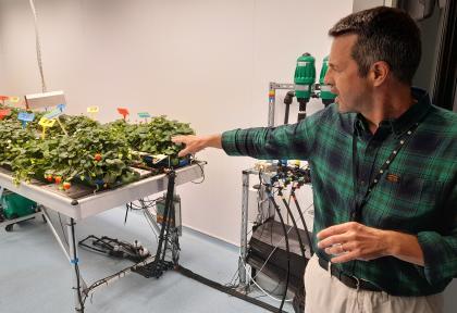 Niab staff member explaining work in a growth room