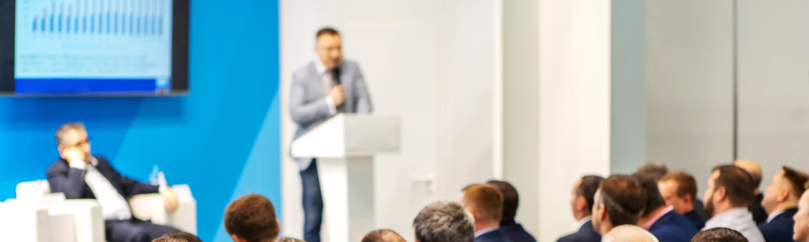 People listening to a speaker at a conference